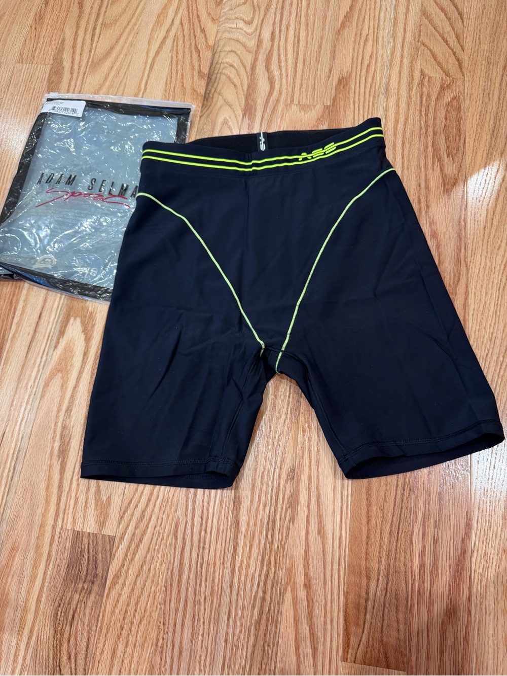 Iconic Adam Selman Sport French Cut Biker Shorts in black with neon green